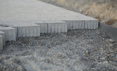 Paved surface in construction with paving stones and gravel, close-up
