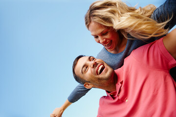 Couple, piggyback and laugh by blue sky on holiday, love and freedom by flying and play together. People, happy and support on travel and romance in outdoor nature, energy and fun on summer vacation