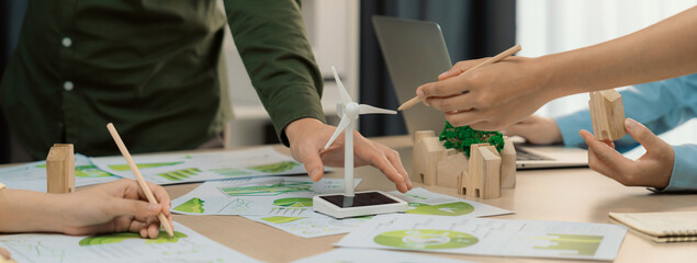 Windmill model represented renewable energy and wooden block represented eco city was placed on...