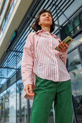 Happy business woman walking outdoors. Business woman doing work while walking.