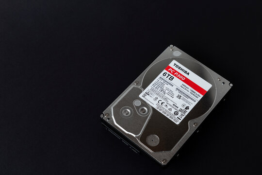 Dnipro, Ukraine - April 13, 2024: 6 TB hard drive, a simple six terabyte 35-inch hard drive from TOSHIBA, close-up isolated on a black background.