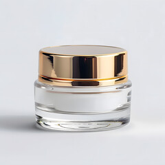 A round glass jar for cosmetics with a gold lid. Packaging for a cream or other cosmetic product