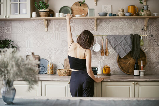 Beautiful girl stand on the kitchen