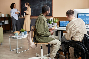 Computer programmers working over new software on laptop in office