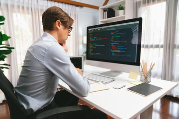 IT developer looking at online software development information on pc align working laptop with...