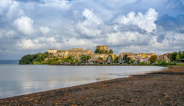 Italy, Lazio, Anguillara Sabazia, Clouds over town on shore of lake Bracciano