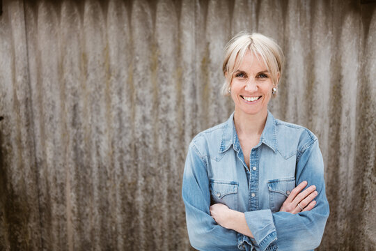 Confident Middle-Aged Woman Smiling Outdoors