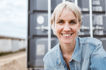 Happy Middle-aged Woman in Denim Shirt Enjoying a Moment Outdoors