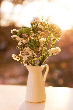 Bouquet of green ranunculus and white chamelaucium flowers