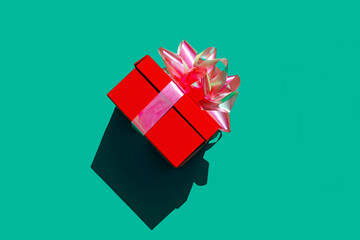 Red gift box against green background