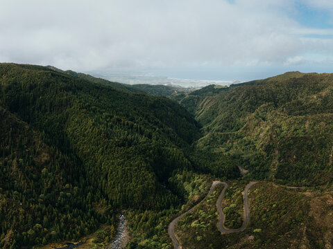 Lombadas waterfall with lush green mountains in San Miguel, Portugal