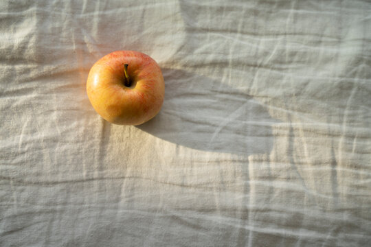 Apple lying on white colored cloth