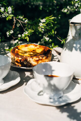 Beautiful served outdoor breakfast with cheesecake and coffee