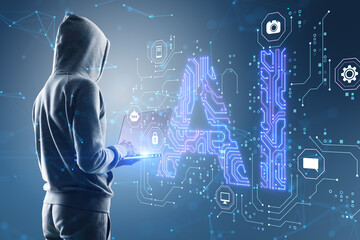 Side view of hacker in hoodie using laptop with glowing blue AI hologram on blurry background....
