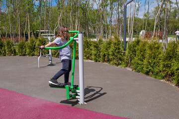 happy child playing sports on the playground during the day. High quality photo