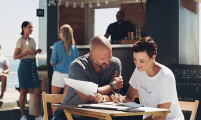 Teamwork, meeting and small business owners with documents at food truck for conversation, planning or discussion on menu. Cafe, manager man and employee woman for collaboration, startup or talking