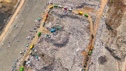 Aerial snapshot unveils the grim reality: Landfill sprawls with towering heaps of refuse,...