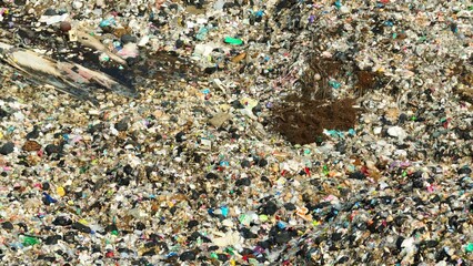 A chaotic mix of trash with varied textures and colors, highlighting environmental concerns related to waste management. Garbage background. Aerial view.
