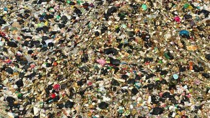 A densely compacted waste, with assorted debris and colorful pieces of plastic, highlighting the...