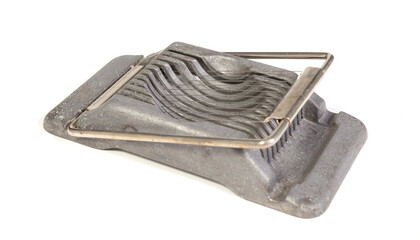 Very old egg cutter isolated