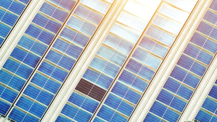 From above, a mosaic of blue solar panels blankets the building's roof, a testament to its...