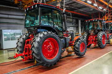 Tractor industry manufacture. New tractors on factory line. Production of agricultural machinery