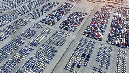 A bird's-eye panorama reveals an expanse of electric cars, harmonizing with nature in a sprawling...