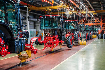 Tractor industry manufacture. New tractors on factory line. Production of agricultural machinery