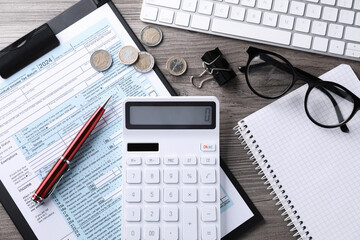 Tax accounting. Flat lay composition with calculator and document on wooden table