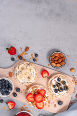 Obraz na płótnie Canvas Rice Crackers Healthy Snack, Crackers Topped with Banana, Fresh Berries, Yogurt and Granola, Breakfast Idea