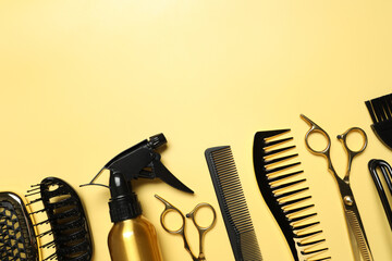 Hairdressing tools on yellow background, flat lay. Space for text