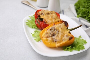 Delicious stuffed peppers on white table, closeup