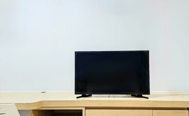 Living room interior with TV. Blank screen television on the table. Television put on tv stand wood table, in minimal empty space. Modern television in living room.