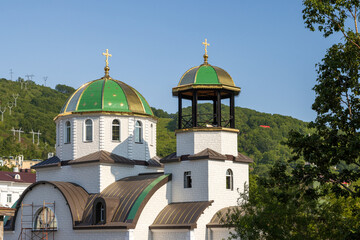View of the church against the blue sky and hills. Alexander Nevsky Church, City of Petropavlovsk-Kamchatsky, Kamchatka Krai, Far East of Russia.