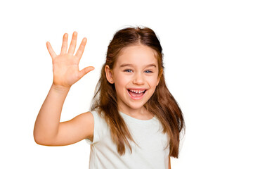 Portrait of her she nice-looking cute attractive lovely pretty cheerful cheery positive pre-teen girl waving hi hello greetings I'm here isolated over bright vivid shine yellow background © deagreez