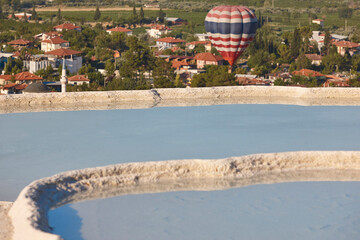 Pamukkale white mineral limestone natural pools and balloon. Turkey