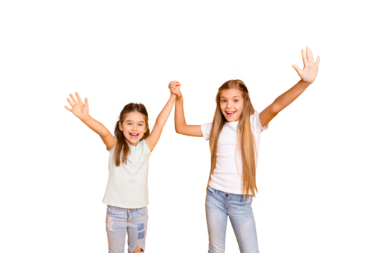 Portrait of two nice cool crazy attractive lovely cheerful cheery positive girlish girls holding hands having fun isolated over bright vivid shine yellow background