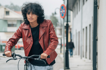 young latin hispanic man with bike on the street