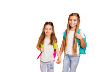 Portrait of two nice-looking attractive lovely cheerful positive pre-teen girls with backpacks holding hands isolated over bright vivid shine yellow background
