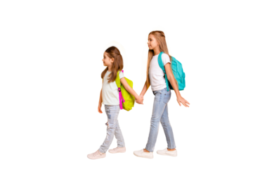 Full length body size profile side view portrait of two nice attractive confident smart clever pre-teen girls with colorful backpacks holding hands isolated over bright vivid shine yellow background