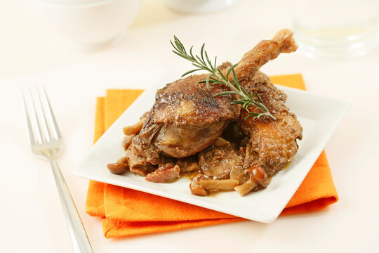 Roasted confit du canard with ham and mushrooms.