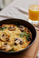 shakshuka with mushrooms, omelette, scrambled eggs with mushrooms in a frying pan, breakfast concept