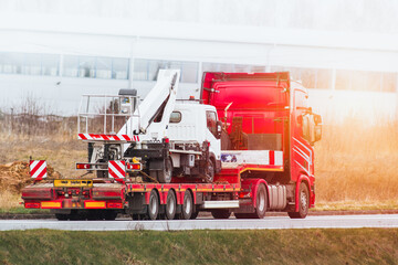 Industrial Excavator and Flatbed Truck Ready for Earthworks - obrazy, fototapety, plakaty