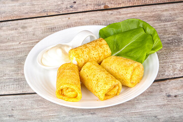 Stuffed pancakes with cream sauce