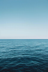 Obraz premium The vastness of the ocean stretching out to the horizon, with just the line where the sea meets the sky in the frame.