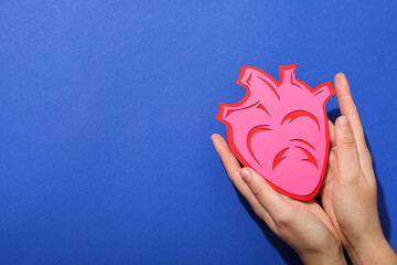 Heart on a blue background, the concept of treating cardiovascular diseases.