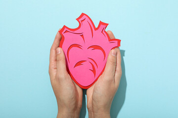 Heart on a blue background, the concept of treating cardiovascular diseases.