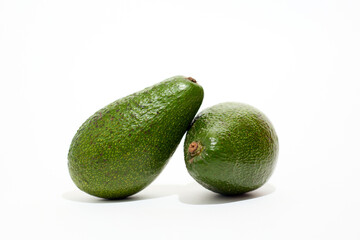 Two Green Avocados Sitting Together
