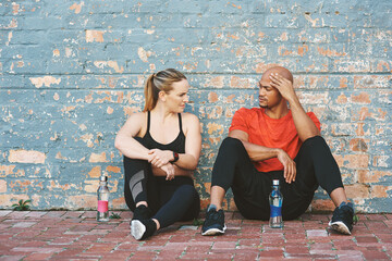 Brick wall, tired and coach with woman for workout, exercise and water bottle for sport. Partnership, personal trainer and athlete on break or fitness at gym for wellness, training and health