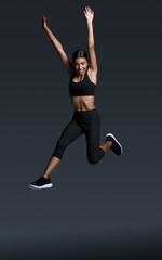 Woman, portrait and jump in studio for workout happiness for healthy exercise, mockup space or...